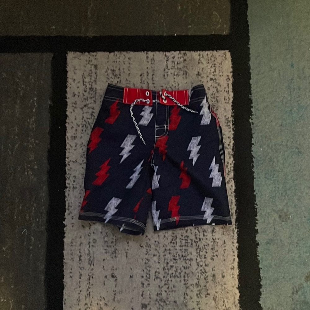 Red white and blue lightning bolt swim trunks